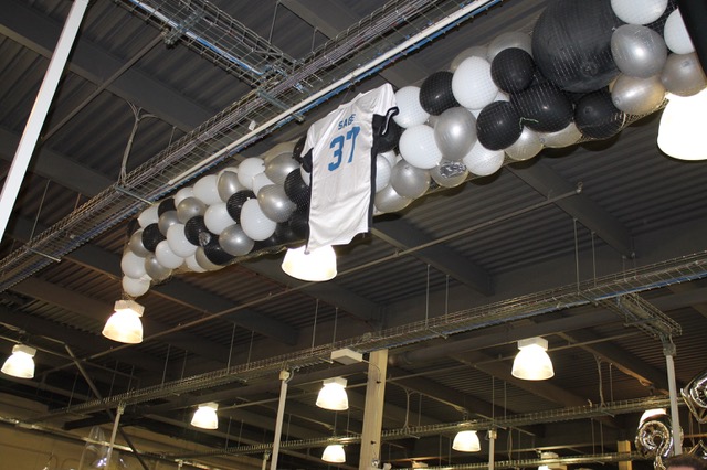 Sports jersey and balloons hung in rafters
